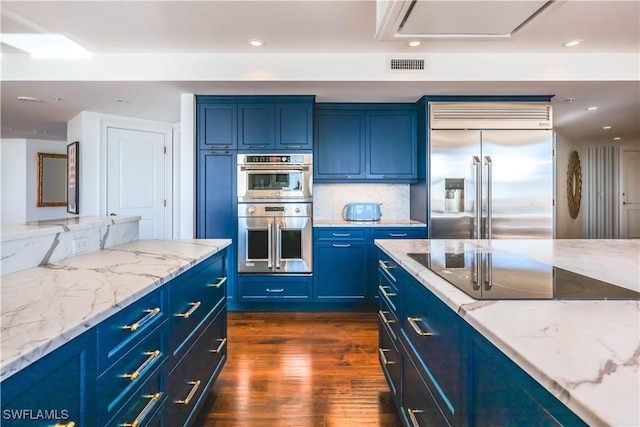 kitchen featuring blue cabinetry, stainless steel appliances, and dark wood-type flooring