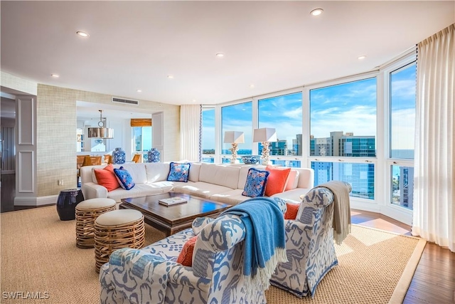 living room featuring a wall of windows and hardwood / wood-style flooring