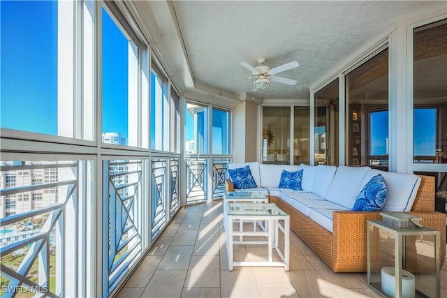 sunroom / solarium featuring ceiling fan and a wealth of natural light