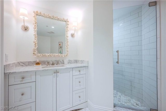 bathroom with a shower with door and vanity