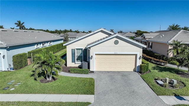 ranch-style home with a front lawn and a garage