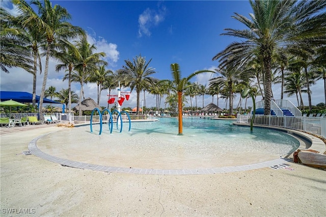 view of swimming pool with pool water feature