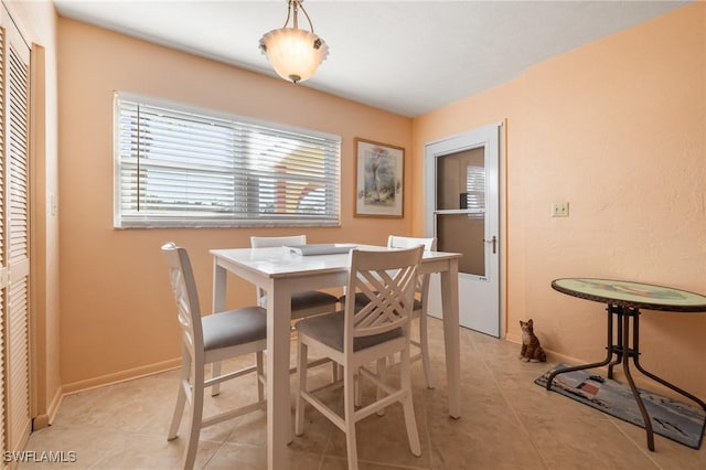 dining area featuring light tile patterned flooring