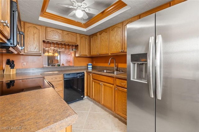 kitchen featuring ceiling fan, sink, a raised ceiling, light tile patterned flooring, and black appliances