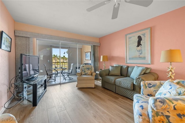 living room with light wood-type flooring and ceiling fan