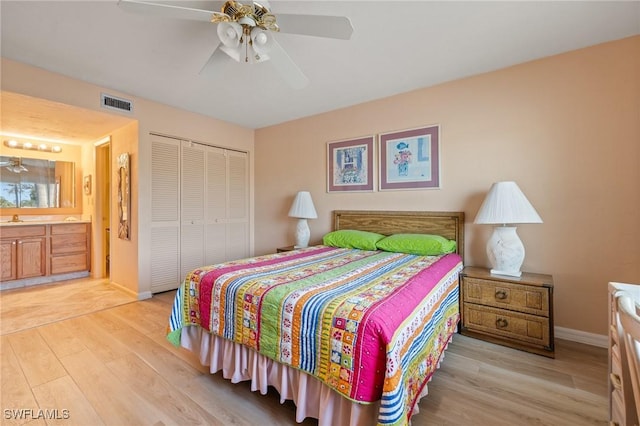 bedroom featuring connected bathroom, ceiling fan, a closet, and light wood-type flooring