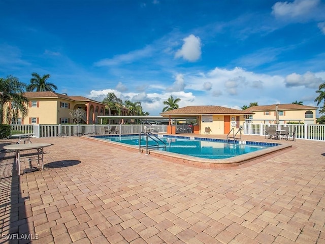 view of swimming pool with a patio