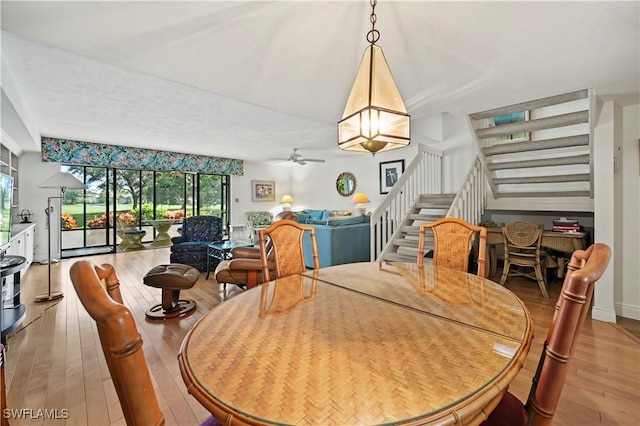 dining area featuring hardwood / wood-style flooring and ceiling fan