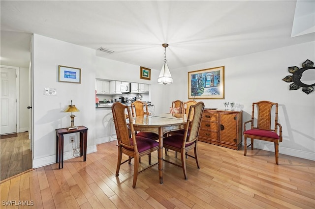 dining room with light wood-type flooring