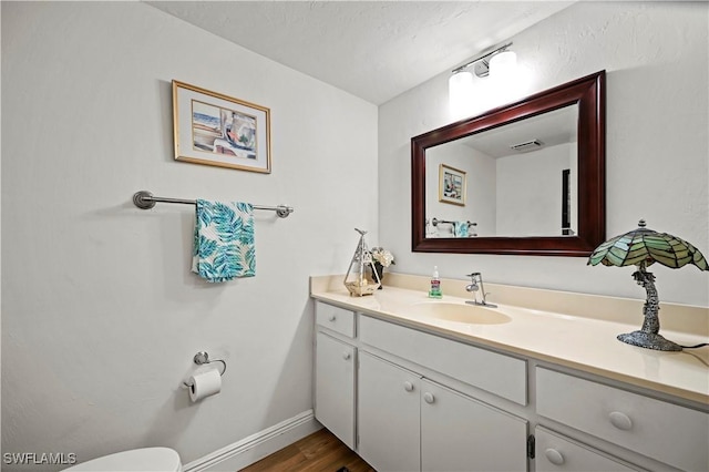 bathroom with vanity and wood-type flooring