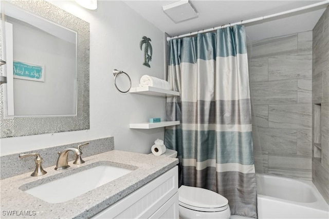 full bathroom with vanity, shower / tub combo, and toilet