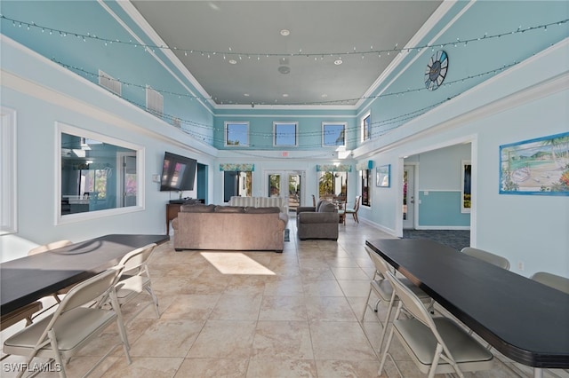 interior space with crown molding and a high ceiling