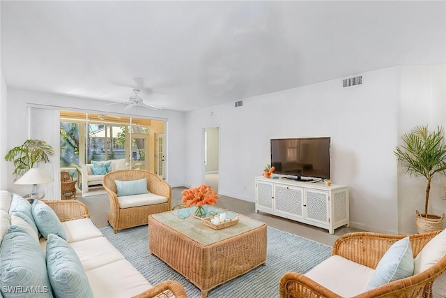 living room featuring light carpet and ceiling fan