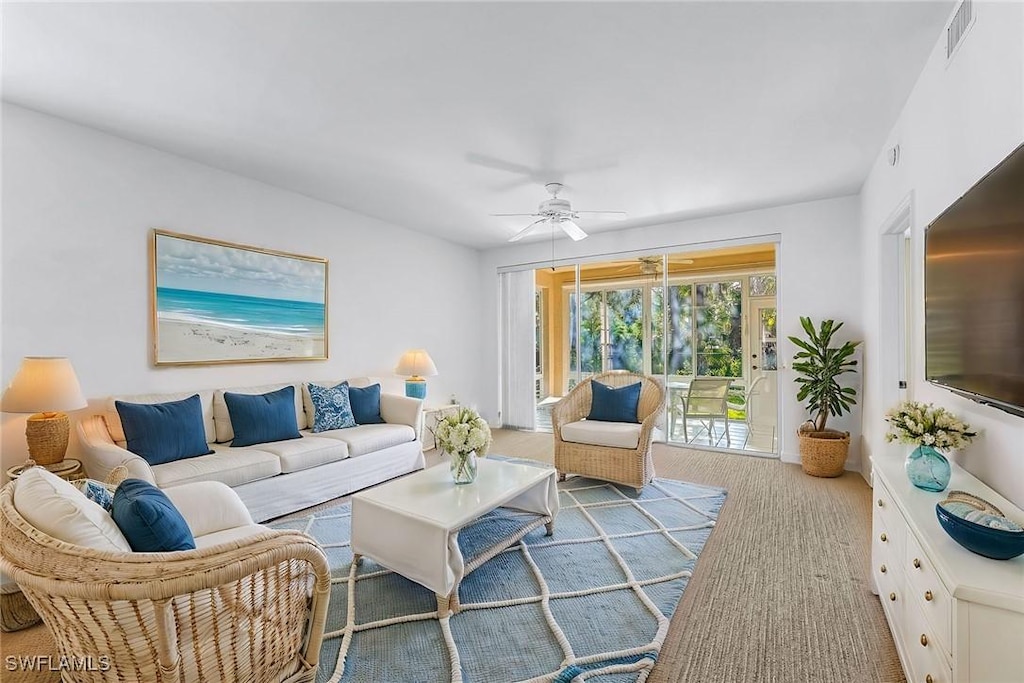 living room featuring ceiling fan and light carpet