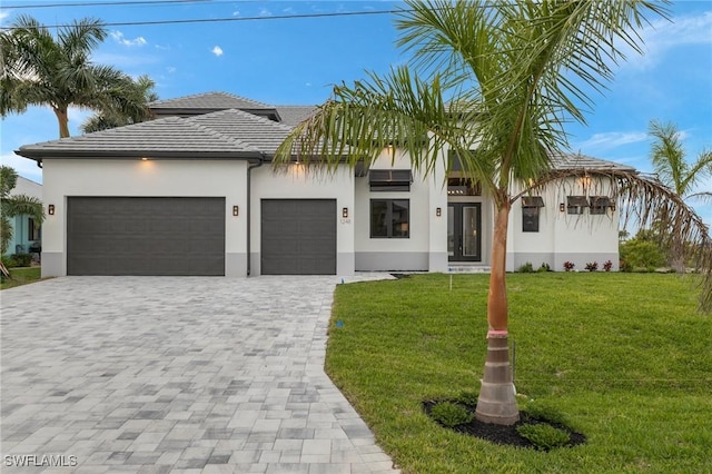 view of front of house with a front lawn and a garage