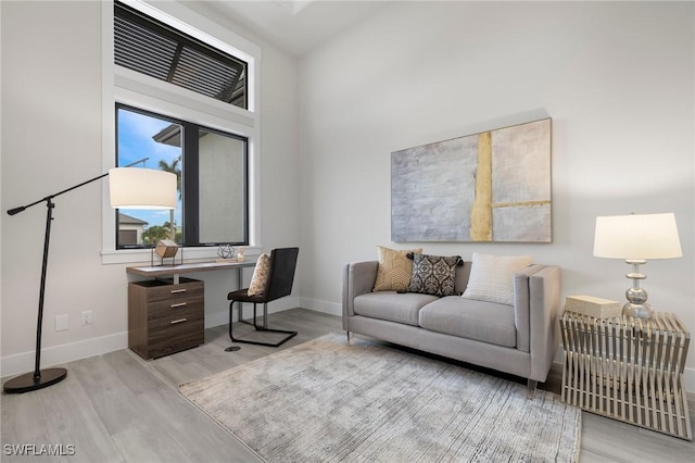 home office with light hardwood / wood-style flooring