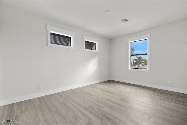 empty room with light hardwood / wood-style floors