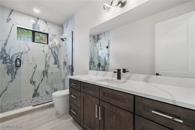 bathroom featuring hardwood / wood-style floors, vanity, toilet, and an enclosed shower