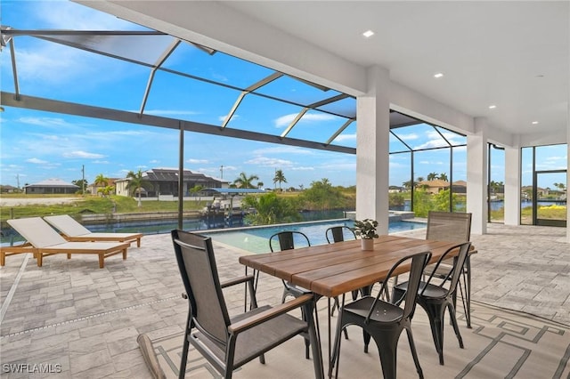 sunroom / solarium featuring a water view