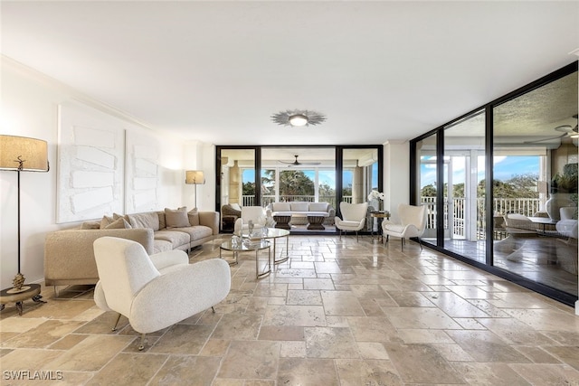 living room featuring french doors, expansive windows, and plenty of natural light