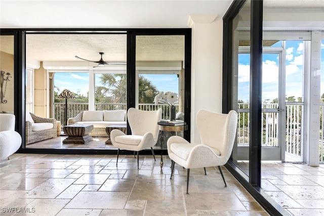 interior space with ceiling fan