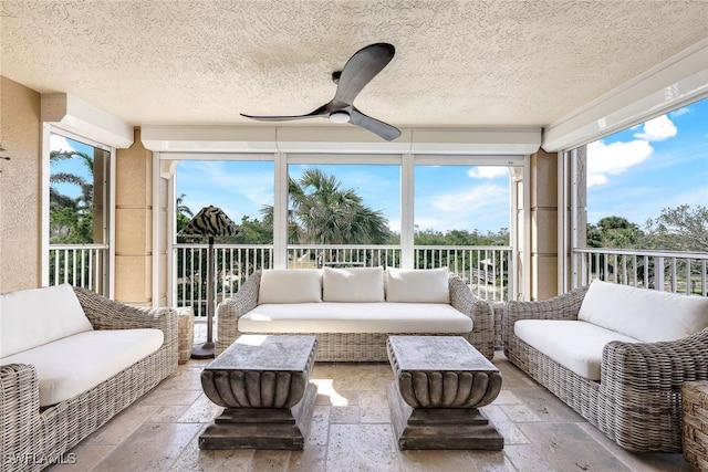 sunroom with plenty of natural light and ceiling fan