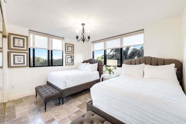 bedroom with a chandelier and multiple windows