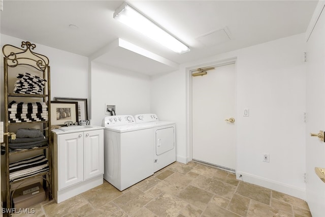 laundry area featuring cabinets and washer and clothes dryer