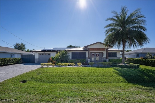 single story home with solar panels and a front yard