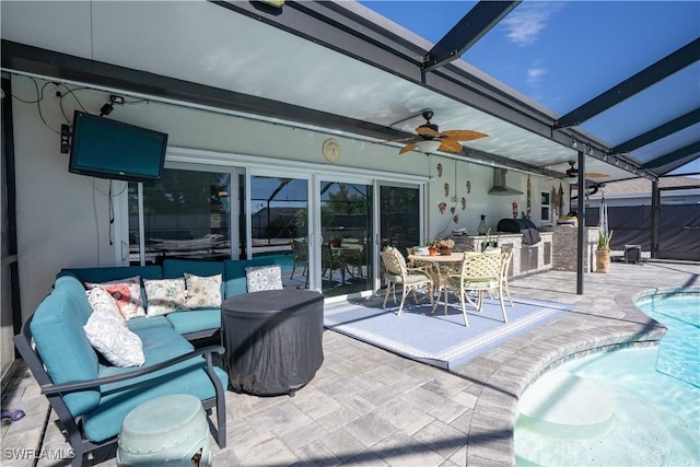 view of patio featuring outdoor lounge area, ceiling fan, area for grilling, and a lanai