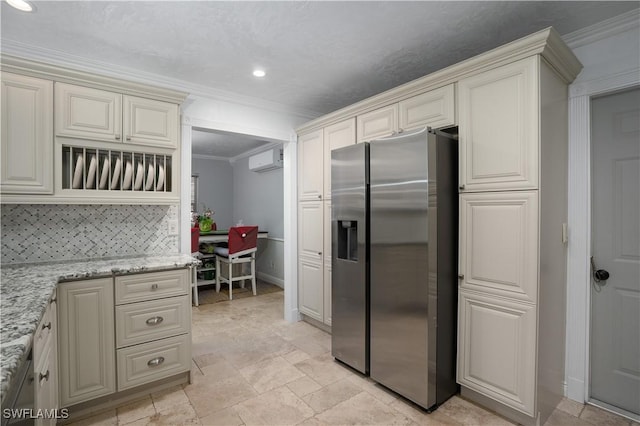 kitchen with backsplash, crown molding, stainless steel fridge, a wall mounted AC, and light stone counters