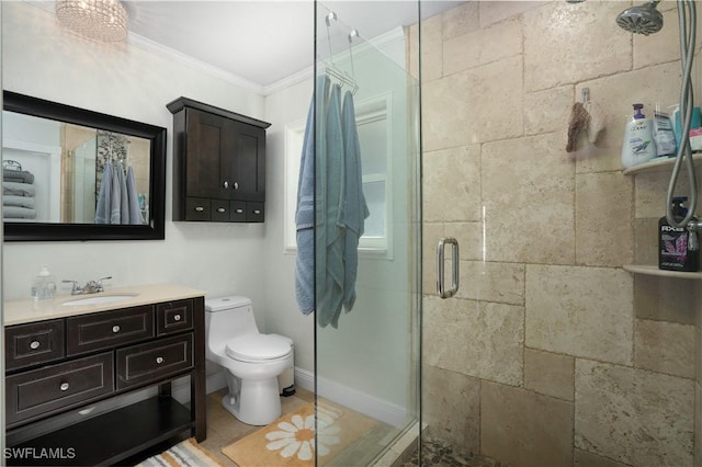 bathroom with crown molding, vanity, an enclosed shower, and toilet