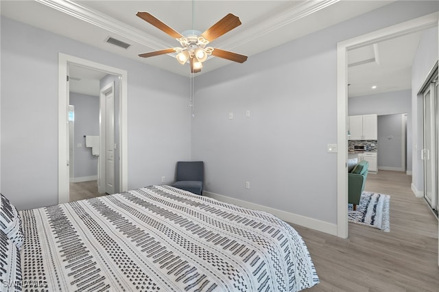 bedroom with light hardwood / wood-style flooring, ceiling fan, and crown molding