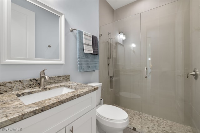 bathroom featuring walk in shower, vanity, and toilet