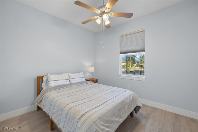 bedroom with hardwood / wood-style floors and ceiling fan