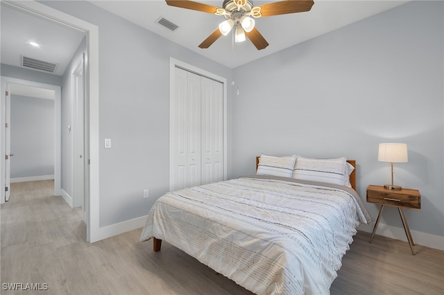 bedroom featuring a closet, ceiling fan, and light hardwood / wood-style floors