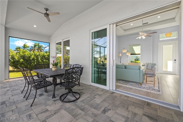 sunroom with ceiling fan and lofted ceiling