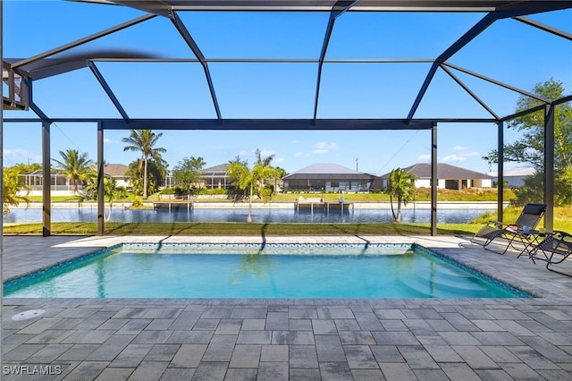 view of pool with a patio, a water view, and a lanai