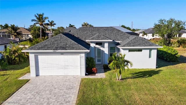 view of front of property with a front yard and a garage