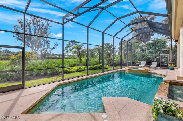 view of swimming pool with an in ground hot tub, a patio, and glass enclosure