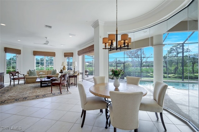 tiled dining room featuring ceiling fan with notable chandelier and crown molding