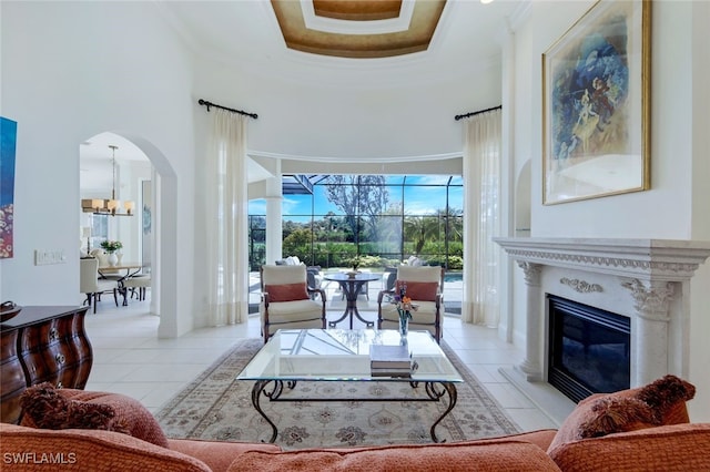 living room featuring light tile patterned floors and a high ceiling