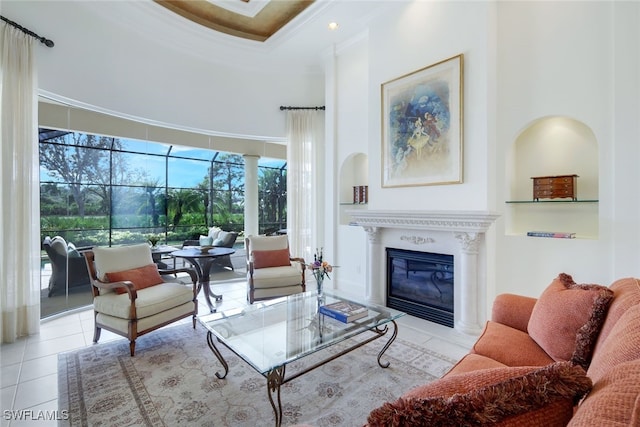 tiled living room with a tray ceiling, crown molding, and a high ceiling