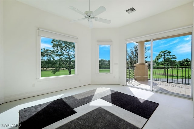 unfurnished sunroom featuring a wealth of natural light and ceiling fan