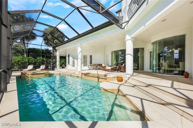 view of swimming pool featuring glass enclosure, a patio area, and an in ground hot tub