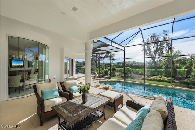 view of swimming pool featuring glass enclosure, a patio area, and an outdoor hangout area