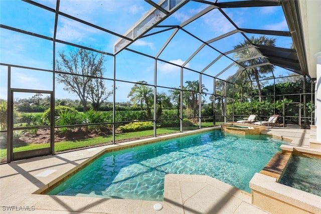 view of swimming pool featuring glass enclosure, an in ground hot tub, and a patio area