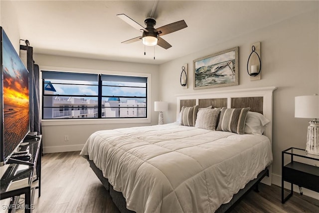 bedroom with ceiling fan and wood-type flooring