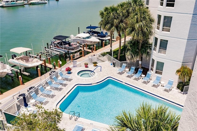 view of pool featuring a water view and a patio area