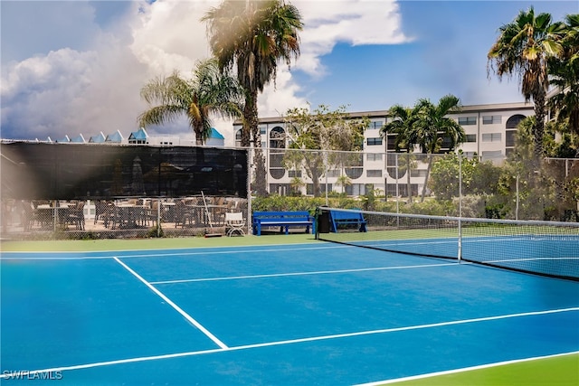 view of tennis court featuring basketball hoop